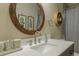 Clean bathroom with round mirror and updated vanity at 3202 Alling, Deltona, FL 32725