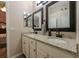 Bathroom with double vanity, granite countertop, and large mirrors at 3202 Alling, Deltona, FL 32725