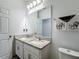 Bathroom with double vanity, granite countertop, and toilet at 3465 Middlebrook Pl, Harmony, FL 34773