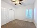 Bright bedroom with ceiling fan, carpet, and window shutters at 3465 Middlebrook Pl, Harmony, FL 34773