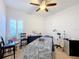 Spacious bedroom with ceiling fan, window, and room for a massage table at 3465 Middlebrook Pl, Harmony, FL 34773