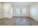 Empty common area with neutral-toned tile flooring and white walls at 3465 Middlebrook Pl, Harmony, FL 34773