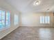 Empty common area with neutral-toned tile flooring and white walls at 3465 Middlebrook Pl, Harmony, FL 34773