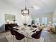 Bright dining room with a large table, chandelier, and stylish chairs at 3465 Middlebrook Pl, Harmony, FL 34773