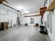 Garage with overhead storage and epoxy floor at 3465 Middlebrook Pl, Harmony, FL 34773