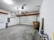 Garage with overhead storage and epoxy floor at 3465 Middlebrook Pl, Harmony, FL 34773