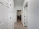 Bright hallway with tile floors and doors leading to other rooms at 3465 Middlebrook Pl, Harmony, FL 34773