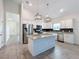 Modern kitchen with stainless steel appliances and island at 3465 Middlebrook Pl, Harmony, FL 34773