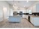 Modern kitchen featuring white cabinets, granite countertops, and a large island at 3465 Middlebrook Pl, Harmony, FL 34773