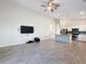 Living room with TV and open view of the kitchen area at 3465 Middlebrook Pl, Harmony, FL 34773