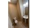 Clean bathroom with pedestal sink and round mirror at 3656 Brighton Park Cir, Orlando, FL 32812