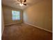 Spacious bedroom with window and ceiling fan at 3656 Brighton Park Cir, Orlando, FL 32812