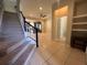 View of the entryway with stairs leading to the second floor and open living and kitchen area at 3656 Brighton Park Cir, Orlando, FL 32812