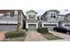 Three-unit townhome complex with attached garages and landscaping at 3656 Brighton Park Cir, Orlando, FL 32812