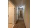 Long hallway with multiple bedroom and bathroom doors at 3656 Brighton Park Cir, Orlando, FL 32812