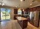 Modern kitchen with dark brown cabinets, granite counters, stainless steel appliances, and island at 3656 Brighton Park Cir, Orlando, FL 32812