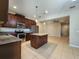 Open kitchen with island and view into adjacent living area at 3656 Brighton Park Cir, Orlando, FL 32812