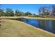 Serene lake view with lush green landscaping at 3656 Brighton Park Cir, Orlando, FL 32812