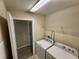 Laundry room with washer, dryer, and access to additional space at 3656 Brighton Park Cir, Orlando, FL 32812