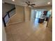 Open living room with tile flooring and a view of the kitchen and stairs at 3656 Brighton Park Cir, Orlando, FL 32812