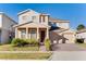 Two-story house with tan siding, red door, and two-car garage at 3975 Great Smokey Way, Apopka, FL 32712