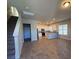 Open living room and kitchen with tile floors at 419 Venetian Palms Blvd, New Smyrna Beach, FL 32168