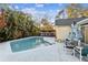 Inviting kidney shaped pool, surrounded by a patio and tropical plants at 4239 Shades Crest Ln, Sanford, FL 32773