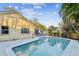 Relaxing kidney-shaped pool with patio and lush tropical landscaping at 4239 Shades Crest Ln, Sanford, FL 32773