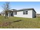 Backyard featuring a newly planted tree and a covered patio at 4508 Windy Oak Way, St Cloud, FL 34772