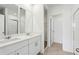 Bright bathroom featuring double sinks, white cabinetry, and walk in shower at 4508 Windy Oak Way, St Cloud, FL 34772