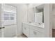 Bathroom featuring double sinks and a view of the carpeted bedroom at 4508 Windy Oak Way, St Cloud, FL 34772