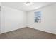 Cozy bedroom with a window, neutral carpet, and a ceiling light fixture at 4508 Windy Oak Way, St Cloud, FL 34772