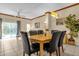 Dining area with light wood table and black leather chairs at 4765 Ormond Beach Way, Kissimmee, FL 34746