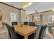 Dining area with light wood table and black leather chairs at 4765 Ormond Beach Way, Kissimmee, FL 34746