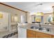 Kitchen with double sink, light wood cabinets, and views into the living room at 4765 Ormond Beach Way, Kissimmee, FL 34746