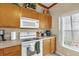 White appliances and light wood cabinets in this well-lit kitchen at 4765 Ormond Beach Way, Kissimmee, FL 34746