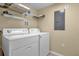 Laundry room with washer, dryer, and shelving at 4765 Ormond Beach Way, Kissimmee, FL 34746