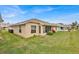 Tan house with a screened porch and well-manicured lawn at 490 Sweetwater Way, Haines City, FL 33844