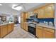 Kitchen with stainless steel appliances and light wood cabinets at 490 Sweetwater Way, Haines City, FL 33844