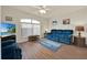 Living room with blue sofa and wood flooring at 490 Sweetwater Way, Haines City, FL 33844