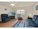 Living room with blue sofas and wood flooring at 490 Sweetwater Way, Haines City, FL 33844