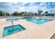 Community pool with a separate spa and lounge area at 490 Sweetwater Way, Haines City, FL 33844