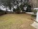 Large backyard with a grassy area and wooden fence at 5022 Log Wagon Rd, Ocoee, FL 34761