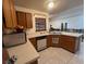 Kitchen with light countertops, wood cabinets, and dishwasher at 5022 Log Wagon Rd, Ocoee, FL 34761