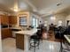 Kitchen with breakfast bar, ample cabinetry, and views to living room at 5022 Log Wagon Rd, Ocoee, FL 34761