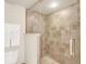 Shower with glass enclosure and neutral tile at 5300 S Atlantic Ave # 604, New Smyrna Beach, FL 32169