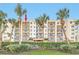 Three-story condo building with balconies and lush landscaping at 5300 S Atlantic Ave # 604, New Smyrna Beach, FL 32169