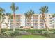 Oceanwalk Condominium building, featuring tropical landscaping and a gated entrance at 5300 S Atlantic Ave # 604, New Smyrna Beach, FL 32169