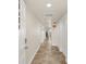 Bright and airy hallway with tile flooring leading to condo rooms at 5300 S Atlantic Ave # 604, New Smyrna Beach, FL 32169