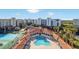 Community pool and tennis courts with surrounding condo buildings at 5300 S Atlantic Ave # 604, New Smyrna Beach, FL 32169